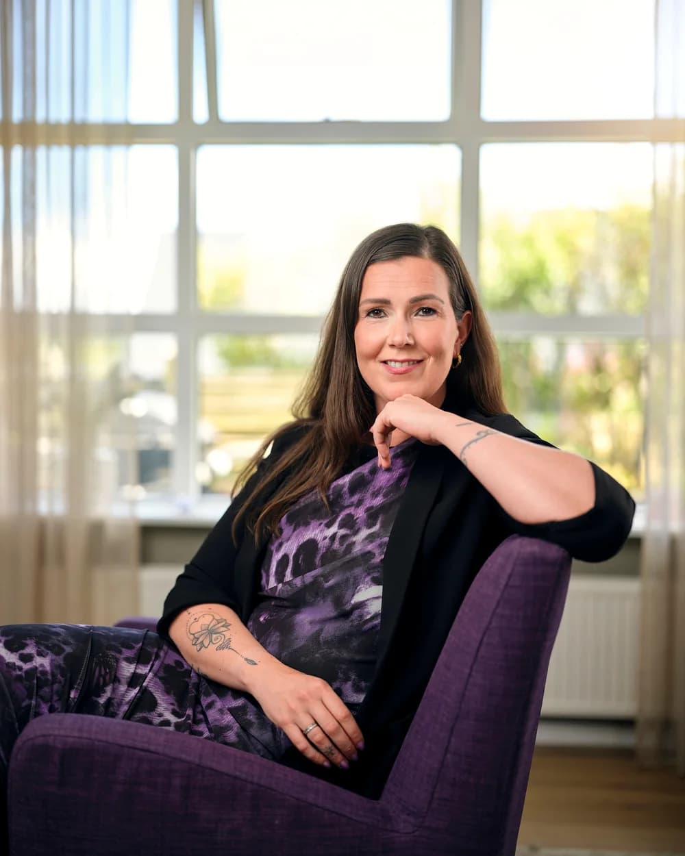 Maríanna, founder of Improvement, seated in her Reykjavík office
